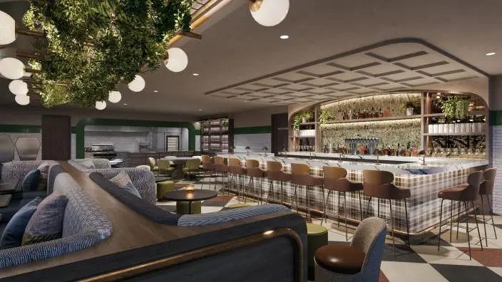 Modern bistro interior with bar seating, hanging plants, lounge seating in foreground, and illuminated shelving with bottles behind counter