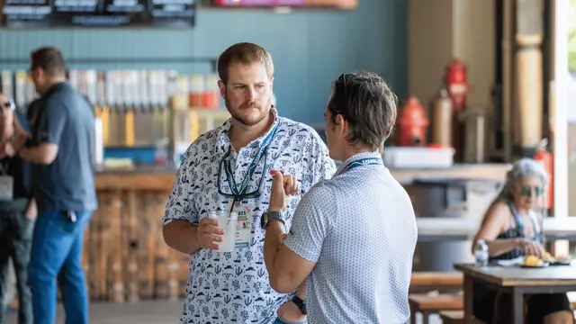 Two men talking together outside