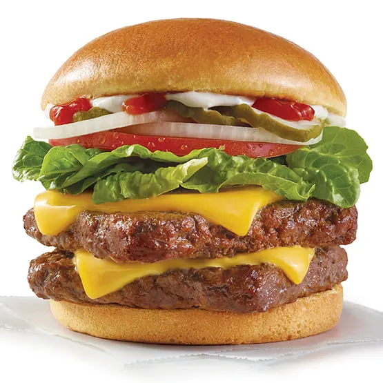 Double cheeseburger with two beef patties, melted yellow cheese, lettuce, tomato, pickles and onions on a sesame seed bun