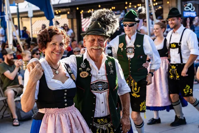 Couple dancing with Oktoberfest themed outfits on