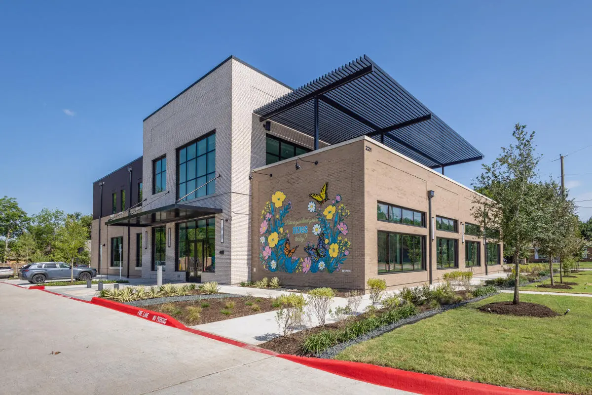 Exterior shot of a new building with a mural on it