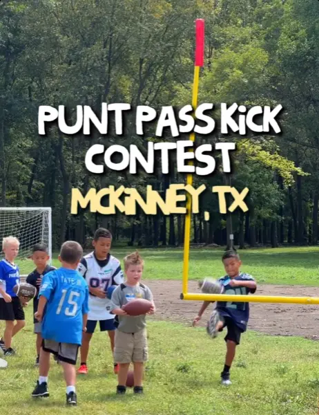 Children in football jerseys participating in a punt pass kick contest on a grass field with yellow goal posts and trees in background
