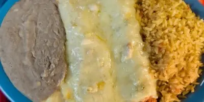 Plate with refried beans, cheese enchilada, and Spanish rice