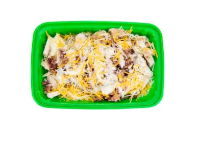 Prepared meal in green container with shredded cheese and mixed ingredients on white rice base