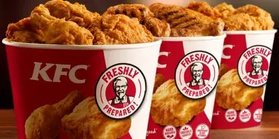 Fried chicken pieces in red and white KFC containers and branded packaging