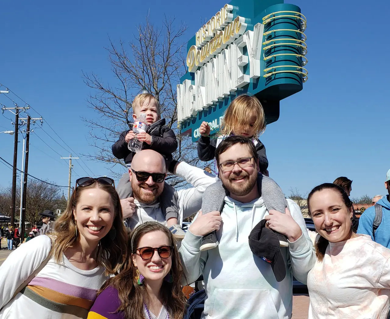 Family posing by downtown McKinney sign