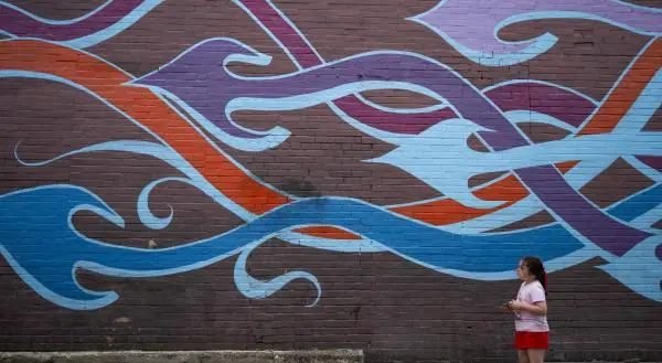 Young girl looking at a mural in Downtown McKinney