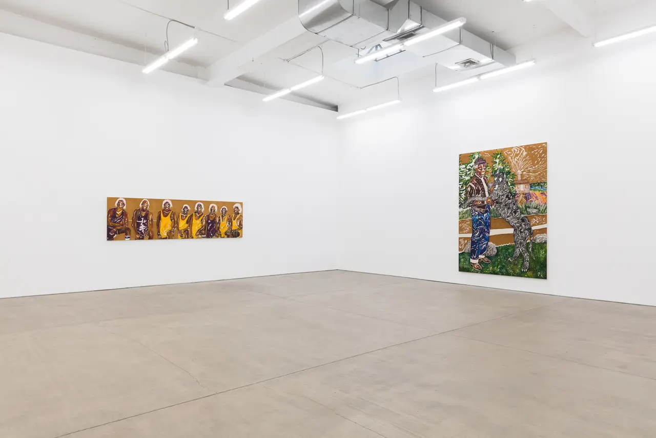 Contemporary art gallery interior with polished concrete floor, white walls, and two colorful paintings hung separately on opposing walls