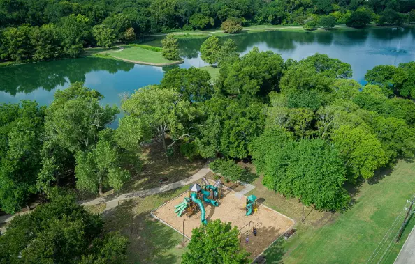 Drone image of a lush green park and playground