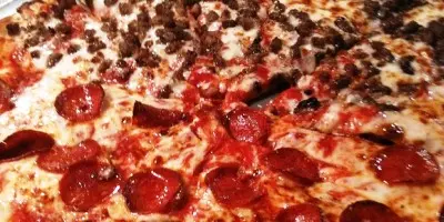 Pepperoni pizza with melted cheese and charred crust