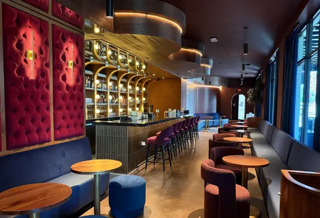 Upscale cocktail bar with red velvet seating