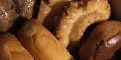 Glazed donuts with golden-brown surface and shiny glaze