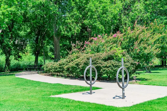 Park in McKinney with green grass and crape myrtle trees