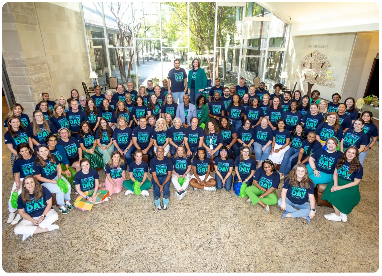 Group of staff posing for a group picture for North Texas Giving Day