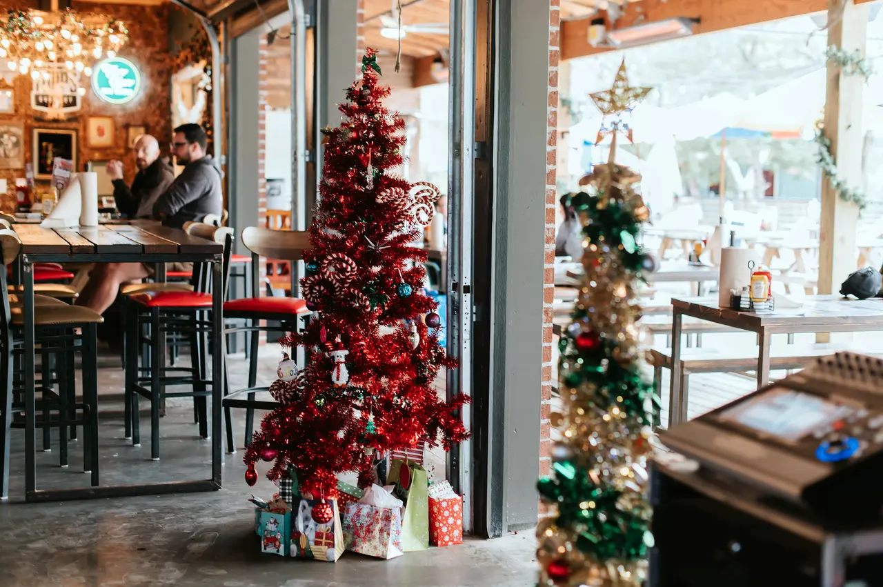 Restaurant with Christmas decorations and trees lighting up the room