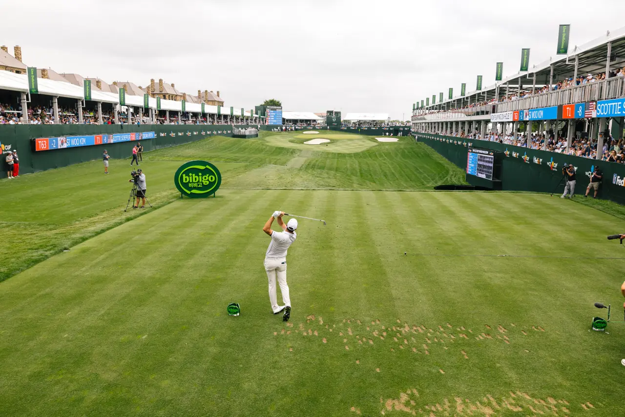 Man golfing on green in a tournament