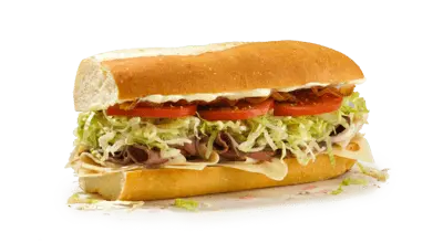 Submarine sandwich with shredded lettuce, tomato, and toppings on toasted roll