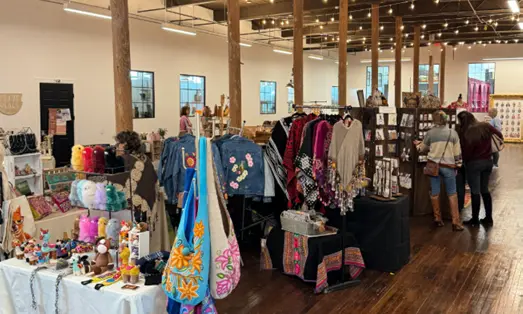 display of handmade purses, jewelry, clothing and more