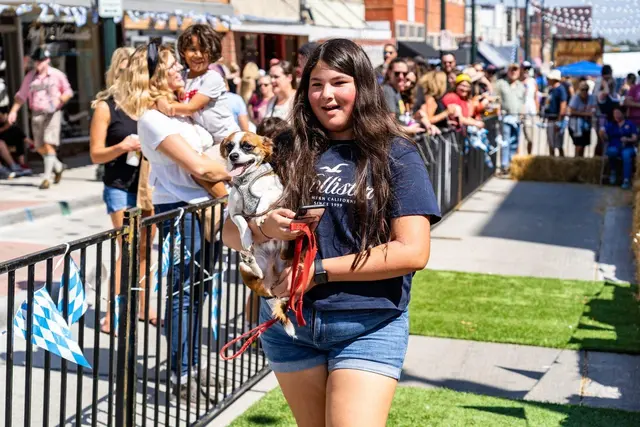 Girl holding a weiner dog 