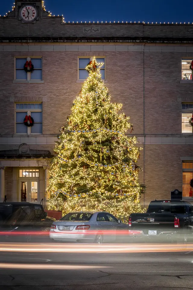 Christmas tree lit up with lights and a big star on top