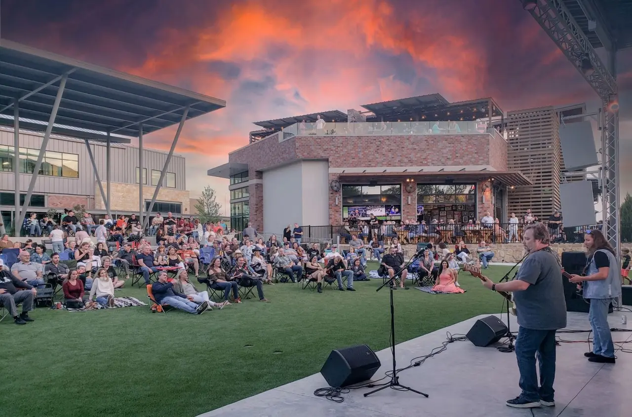 Band playing on stage at Hub 121 amphitheater
