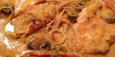 Creamy pasta dish with mushrooms and red peppers in rich sauce