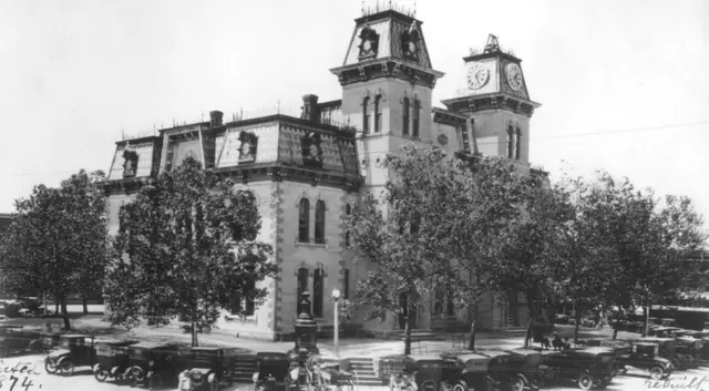A walking tour group among the historic storefronts of downtown McKinney