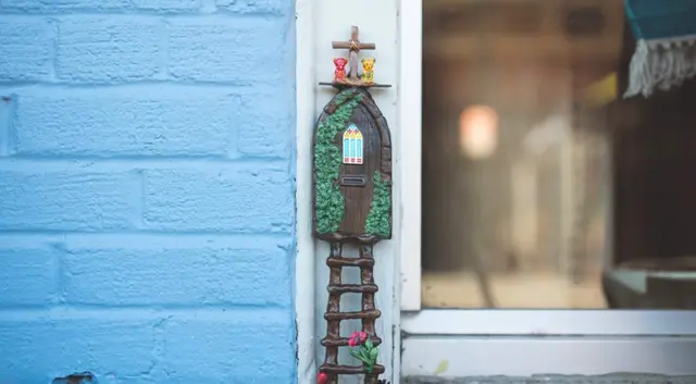 A tiny painted fairy door in downtown McKinney