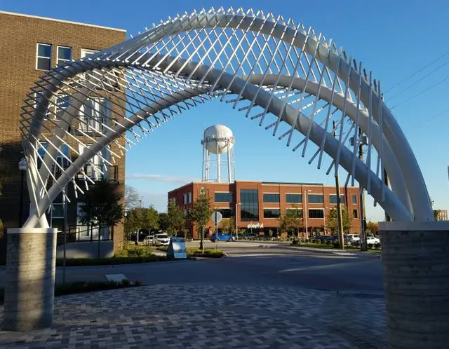 Sculptural arches framing the downtown McKinney water tower