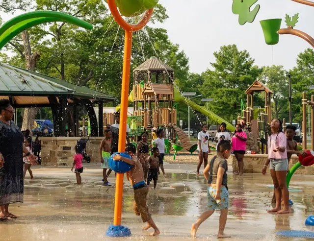 Kids running through a splash pad in McKinney