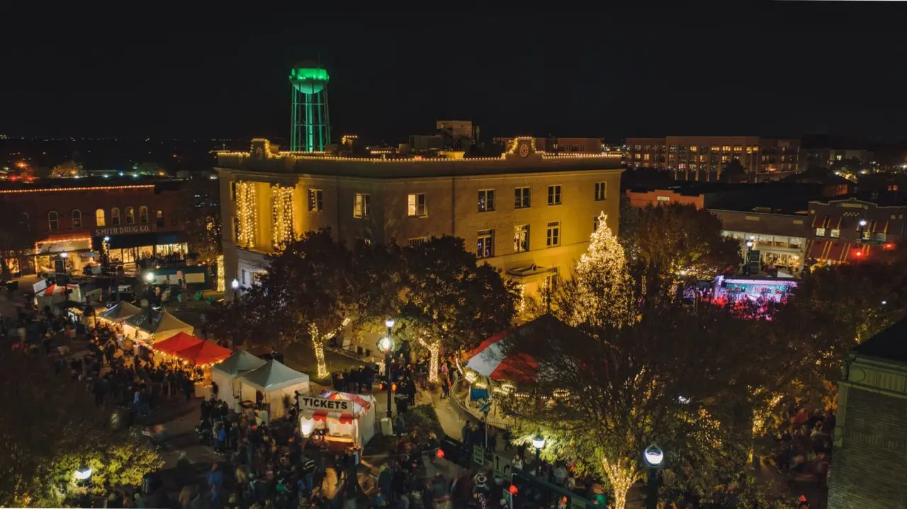 Christmas lights, tree and water tower in downtown McKinney at night during Home for the Holidays