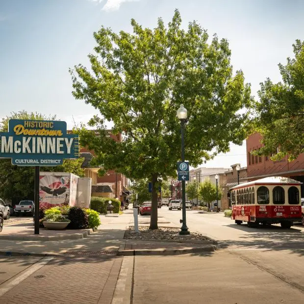 The downtown McKinney welcome sign and trolley, a block from the Visitor Center