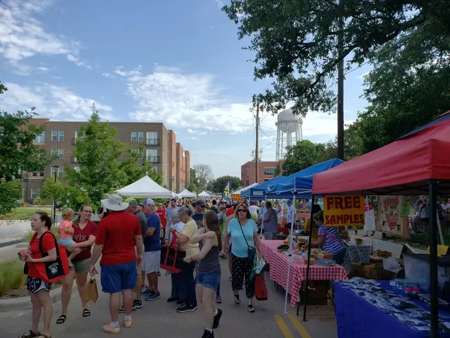 Shoppers browsing produce tents at the McKinney Farmers Market