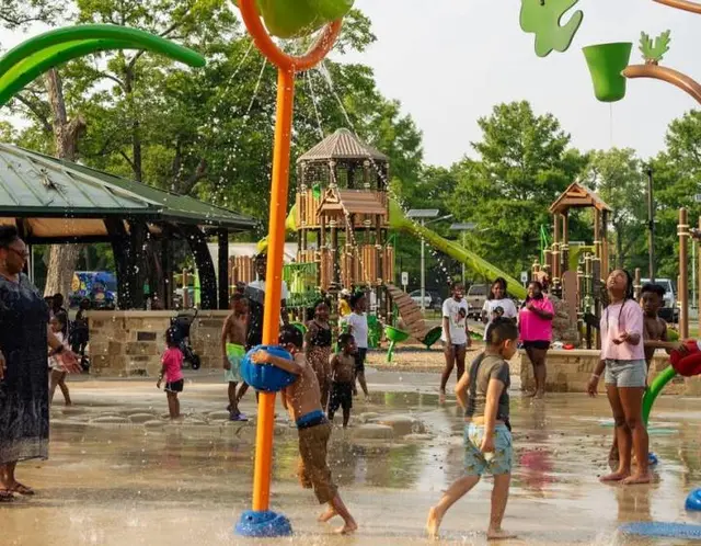 Kids running through a splash pad in McKinney