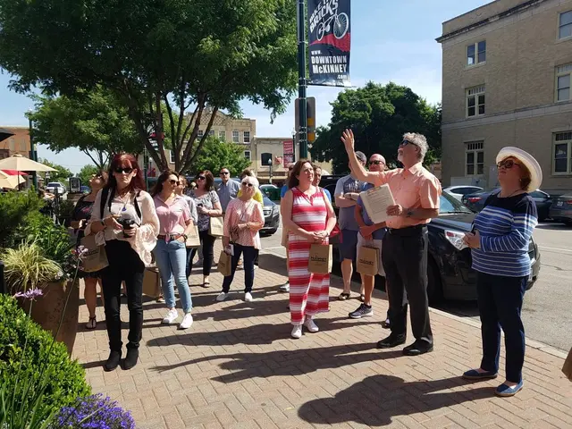 A tour guide leading a group through downtown McKinney