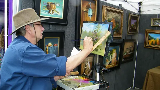 An artist painting at the Arts in Bloom festival