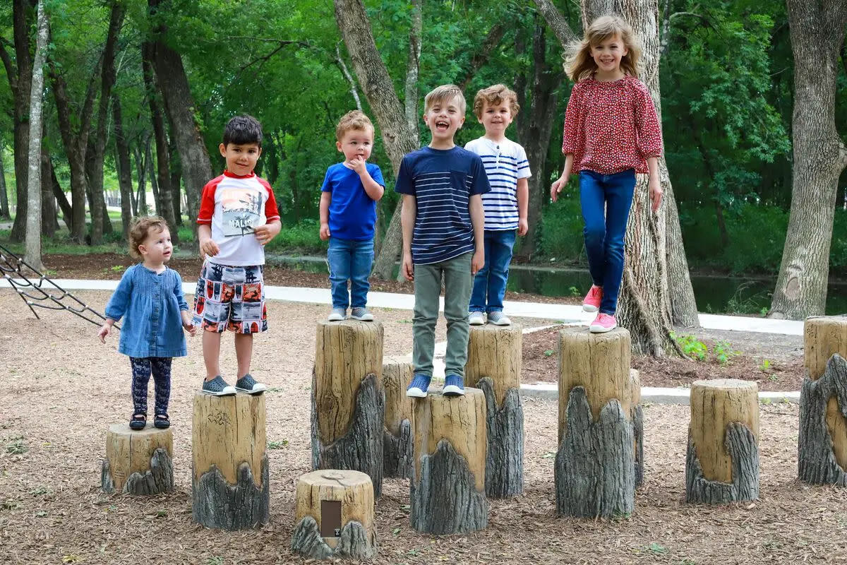 Kids climbing on a playground structure in McKinney