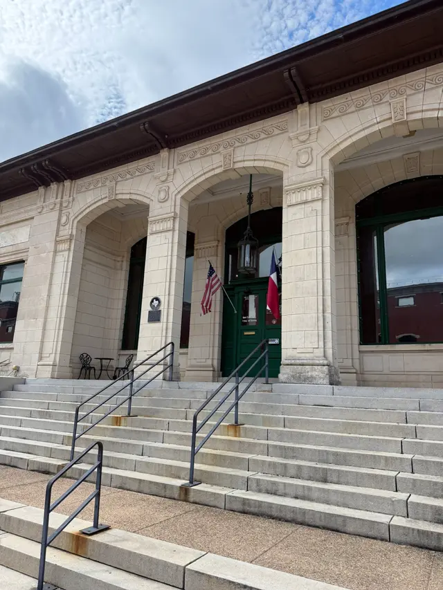 The limestone arches and green doors of the 1911 post office that houses the Collin County History Museum
