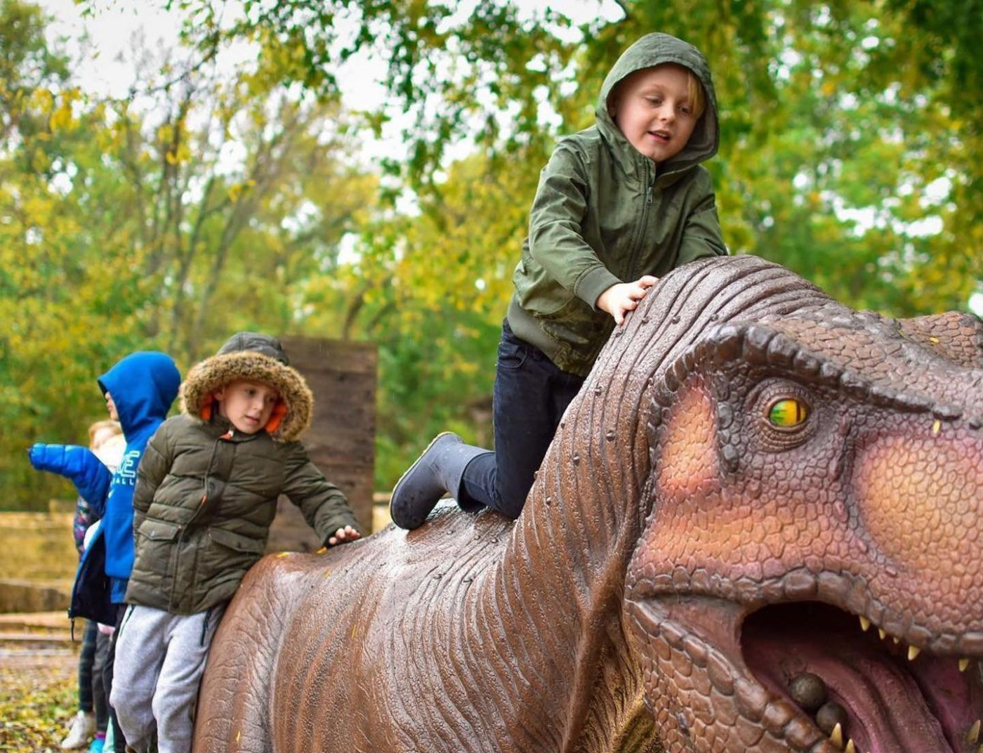 Children climbing on the dinosaur sculpture at the Heard Natural Science Museum
