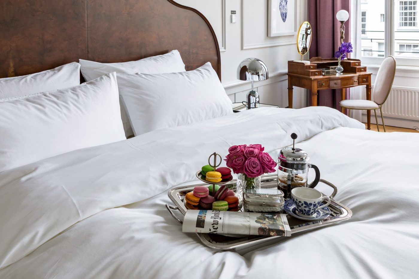A comfortable hotel room with a made bed and seating area in McKinney, Texas