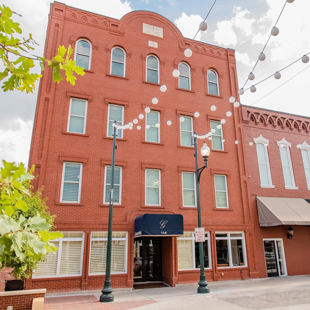 The Grand Hotel, a historic brick boutique hotel on the downtown McKinney square